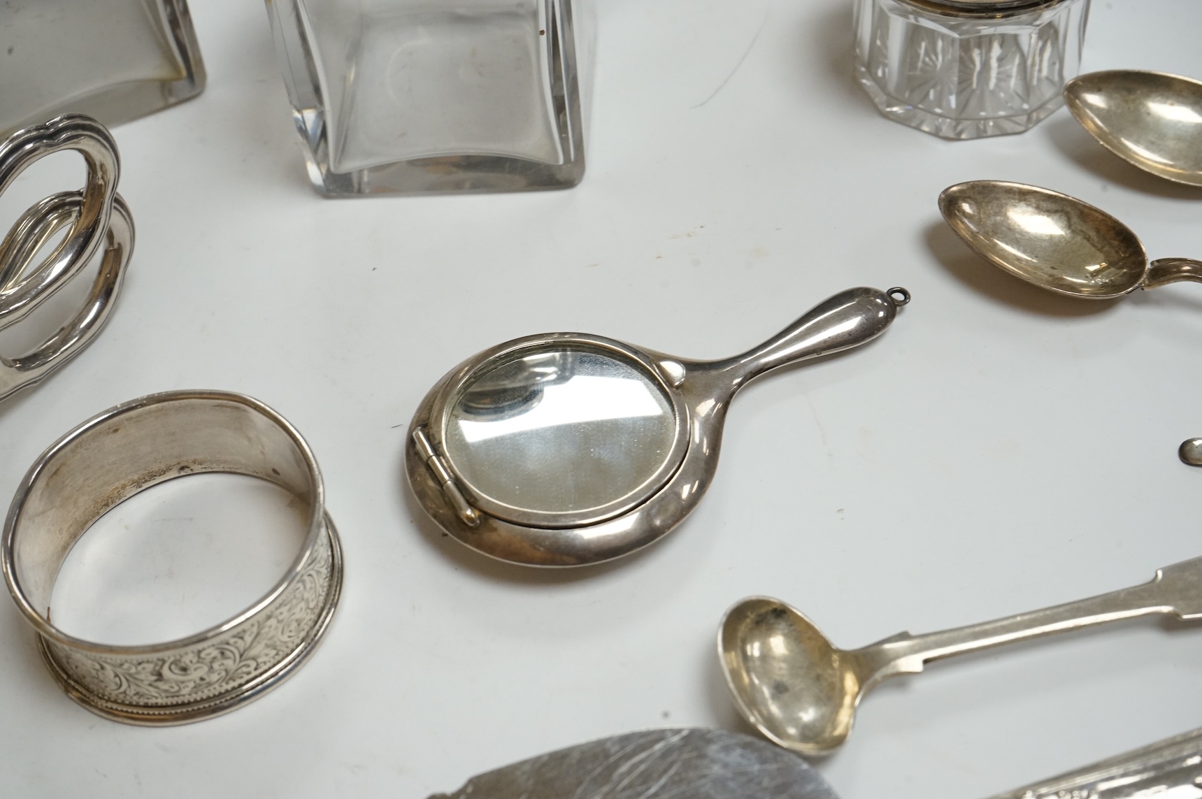 A late Victorian repousse silver mounted rectangular easel mirror, Birmingham, 1896, 35.7cm(a.f.), together with a modern silver mounted photograph frame, a silver handbag mirror/compact, three mounted glass toilet jars,